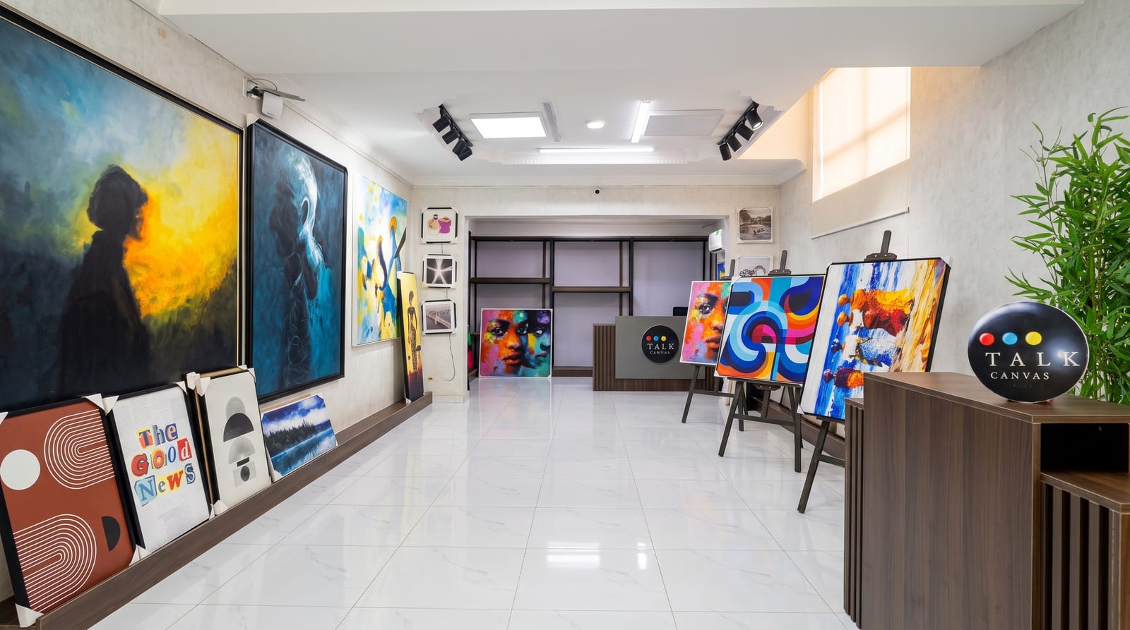 Talk Canvas showroom with paintings on easels and the reception desk