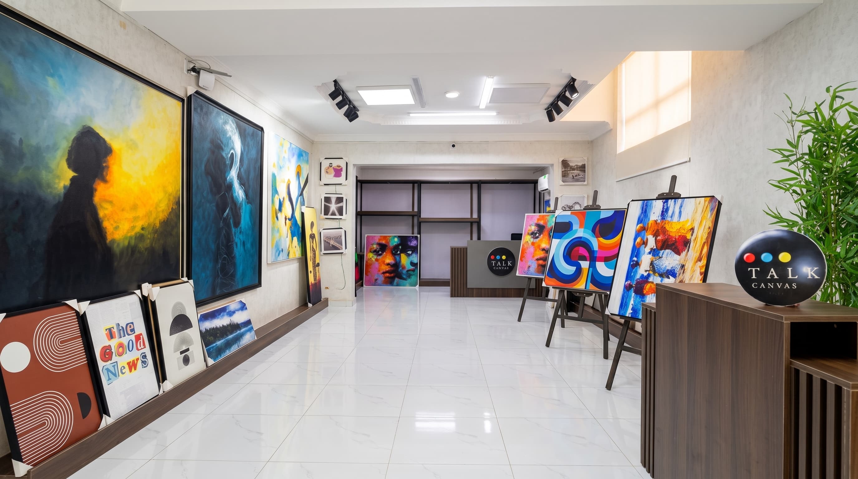 Talk Canvas showroom with paintings on easels and the reception desk